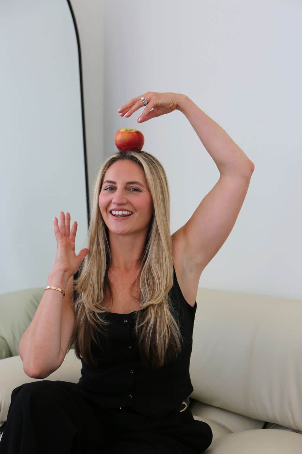 registered dietitian nutritionist food and nutrition philosophy Kerry McCarthy balancing an apple on her head for her registered dietitian nutritionist food and nutrition philosophy blog post.